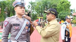 Bupati Karimun Aunur Rafiq menyematkan pin tanda operasi kepada perwakilan petugas Ops Ketupat 2023. (Foto: Humas Polres Karimun)