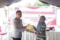 Kapolres Karimun AKBP Fadli Agus menyerahkan sembako murah kepada masyarakat Telaga Mas. Foto: Humas Polres Karimun