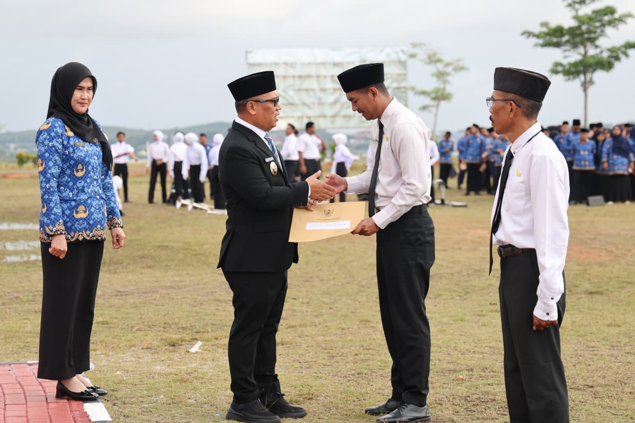 Wagub Nyanyang Haris Pratamura didampingi Kepala BKD Kepri Yeny Trisia Isabella menyerahkan SK kepada perwakilan PPPK Paruh Waktu yang disejalankan dalam peringatan Hari Pahlawan di Kantor Gubernur, Dompak, Tanjungpinang. (Enji/DISKOMINFO KEPRI)